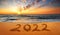 Happy New Year 2022! Written 2022 on the beach. Happy New Year 2022 is coming concept sandy