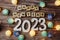 Happy New Year 2023 decorate with LED cotton ball on wooden background