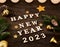 \'Happy new year 2023\' made with wooden letters, numbers on a wooden table