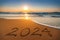 Happy New Year 2024 concept, lettering on the beach. Sea sunrise
