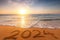 Happy New Year 2024 Text on Tropical Beach Sand and Turquoise Water of Caribbean Sea Wave and Ocean Horizon at Sunrise
