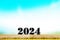 Happy new year 2024 ,Wood table top on blurred of blue sky and white clouds