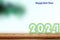 Happy new year 2024 ,Wood table top on blurred of sky blue background with coconut leaf