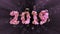 Happy New Year Banner with 2019 trendy pink color Numbers made by shattered cracked stone with flying glass or water