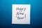Happy New Year card with text on blue background