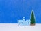 Happy New Year congratulation in Russian language with christmas tree on blue background