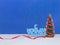 Happy New Year congratulation in Russian language with christmas tree on blue background