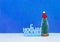 Happy New Year congratulation in Russian language with christmas tree in red cap on blue background