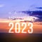 Happy New Year greeting card 2023, Happy New Year 2023 letters on the mountain with sunset on mountains landscape in twilight time