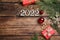 Happy New Year greeting card. Flat lay composition with 2022 numbers and festive decor on wooden background