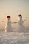 Happy New Year with Snowman. Snowmans happy couple. Snowmans celebration. Santa claus hat in winter.