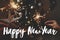 Happy New Year text on fireworks lights in couple hands on background of christmas tree and glowing star. Season`s greetings card