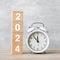 Happy New Year with vintage alarm clock and 2024 block. Christmas, New Start, Resolution, countdown, Goals, Plan, Action and