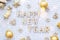 Happy New Year wooden letters on cozy festive white knitted background with sequins, stars, lights of garlands. Greetings,