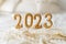 Happy New Years 2023. Christmas background with 2023 candles and white knit sweater.