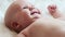 Happy newborn baby smiling closeup