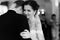 Happy newlywed bride and groom dancing at wedding reception closeup b&w