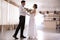 Happy newlywed couple dancing in festive hall