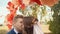 Happy newlywed couple kissing on the romantic wedding aisle with decorations in the form of flowers.