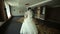 Happy newlyweds dance a waltz in a room with a beautiful modern interior.