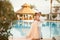 Happy newlyweds hug on the villa next to the swimmimg pool during the honeymoon