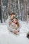 Happy newlyweds are hugging in the winter forest. Couple in love. Winter wedding ceremony.