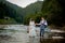 Happy newlyweds standing and smiling on the river . Honeymooners, photo for Valentine`s Day