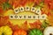 Happy November alphabet letter with pumpkin and maple leaves decoration on yellow background