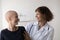 Happy nurse support sick female cancer patient