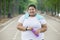 Happy obese woman holds a bottle of water