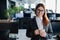 Happy office manager wearing glasses and headset holding mug. smiling female call center employee is politely answering