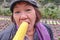 Happy old asian women eat tasty corn with delicious face in xihu lake park hangzhou china