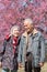 Happy old couple smiling in a park.mature couple with cherry blossom sakura tree.seniors lover family and healthcare concept