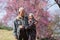 Happy old couple smiling in a park.mature couple with cherry blossom sakura tree.seniors lover family and healthcare concept