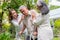 Happy old elderly Asian man uses a walker and walks in the backyard with him Nurse and wife. Concept of happy retirement With