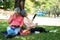 Happy old elderly couple spouses relaxing and sitting on a blanket in the park and sharing few precious memories. Senior couple