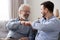 Happy old father and young son laughing giving fist bump