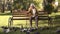 Happy old lady sitting on bench in park, feeding pigeons, elderly leisure time