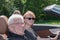 Happy older couple drives with a luxury convertible car