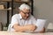 Happy older senior landlord man in glasses reviewing document