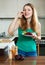 Happy ordinary woman in green eating beets