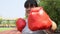 Happy overweight Asian woman wears Red boxing gloves Try to lose weight by exercise in the garden by punching. Concept of Health