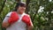 Happy overweight Asian woman wears Red boxing gloves Try to lose weight by exercise in the garden by punching. Concept of Health