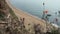 Happy pair standing staircase beach with wildflowers on foreground. Couple rest.