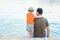 Happy parent with child on the sea shore background