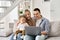 Happy parents and child son waving having virtual meeting using laptop at home.