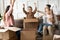 Happy parents with children celebrating relocation, playing with boxes