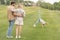 happy parents embracing and looking at cute little daughter performing handstand