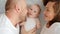 Happy parents with his newborn baby, top view. Happy family. Healthy newborn baby with mom and dad. Close up Faces of the mother,