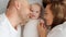Happy parents with his newborn baby, top view. Happy family. Healthy newborn baby with mom and dad. Close up Faces of the mother,